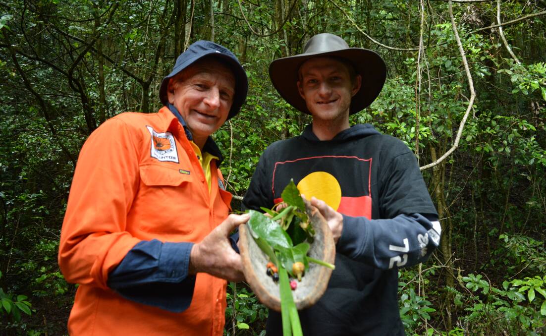Forest full of food: Glenn Jonas and Boe Clarke help uncover the bush tucker goodies growing in Copeland Tops. Photo Anne Keen