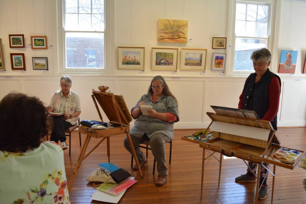 Living art: Maureen Clunas, Tracey Murrell and Jean Spokes sketch fellow Art Society member, Helene New. Photo: Anne Keen