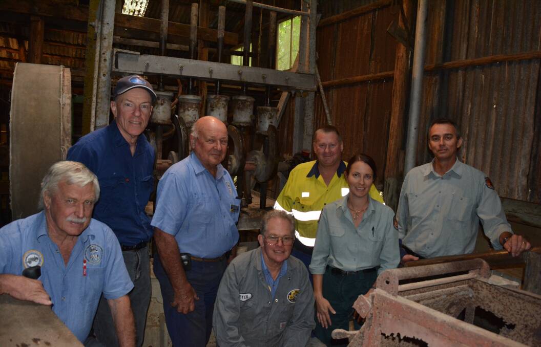 Members of the Hunter Valley Vintage Farm Machinery Club with NPWS staff Coralie De Angelis and Anthony Signor with the stamper machine. Photo Anne Keen