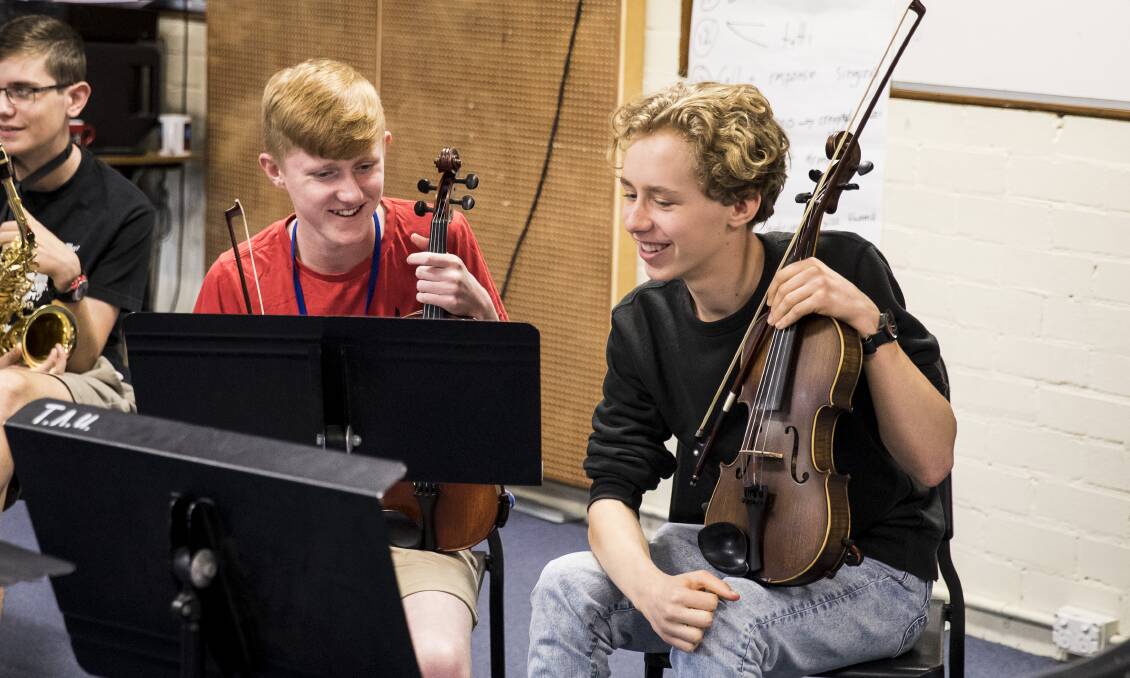 Zeke Llewellyn (left) worked with his violin during the five-day workshop in Sydney, with fellow violinist Thomas Nix from Rose Bay Secondary College. Photo supplied