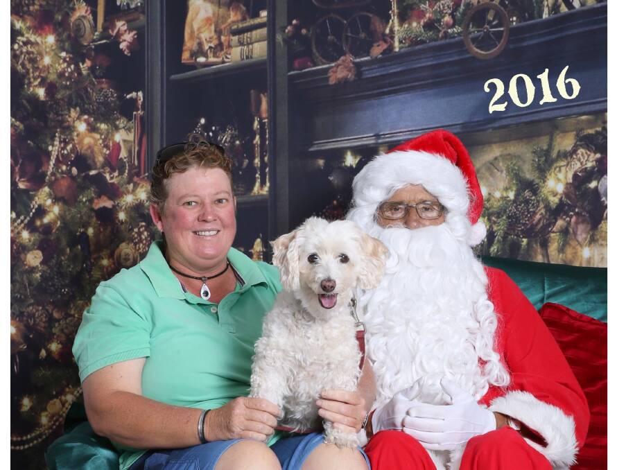 Anne Fenning fulfilled her childhood dream of having her photo taken with Santa last year with her dog, Sandy, a Jackoodle. Picture: Sharon Benson Photography