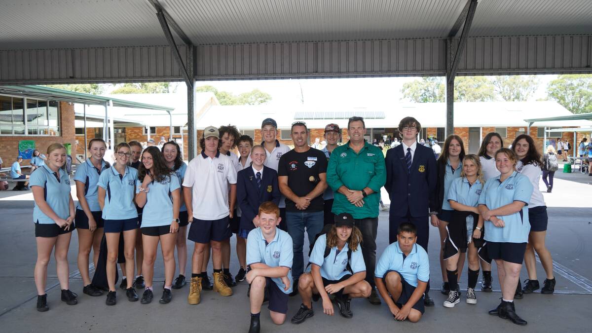 Brad Fittler and Gus Worland pose for a photo with a few of the Gloucester High School students. Photo supplied by NSWRL 