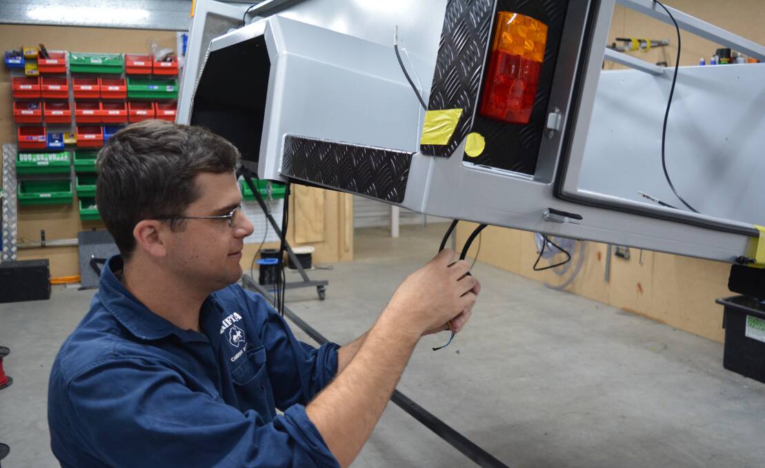 Brett Kerr working on the electrical fit-out of a DOT (Drifta Offroad Tourers) trailer. Photo Anne Keen