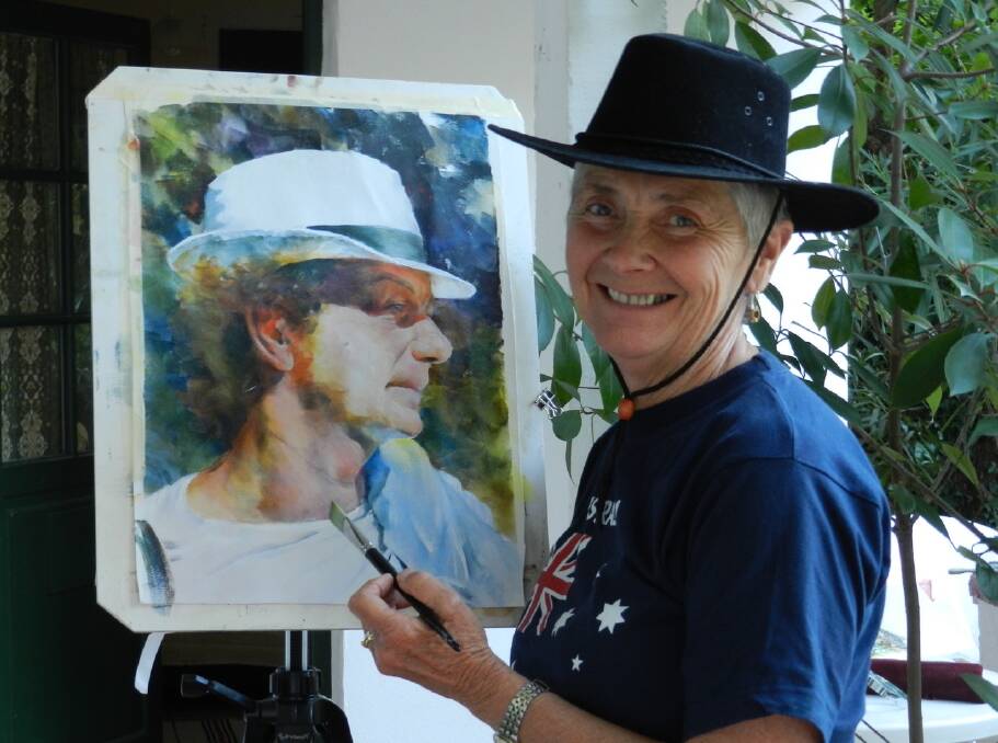 For the love of art: Jean Spokes painting a portrait of a man in France during a painting retreat with good friend, Jean Buettel in 2014. Photo: supplied. 