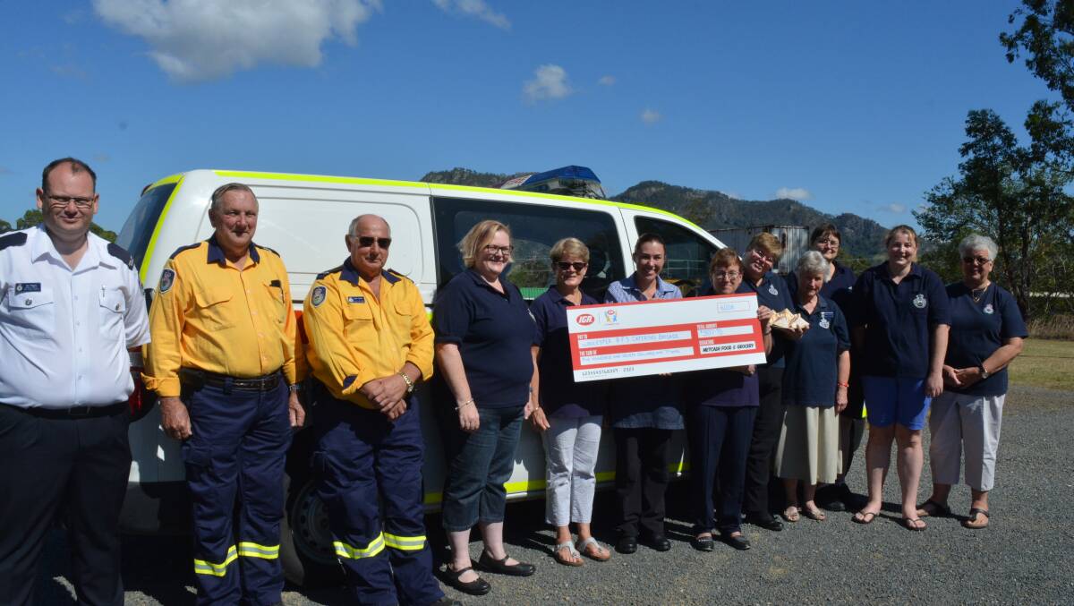 Volunteers from the Gloucester Rural Fire Service Catering Brigade accept the cheque from Lovey’s Grocers IGA Community Chest program.