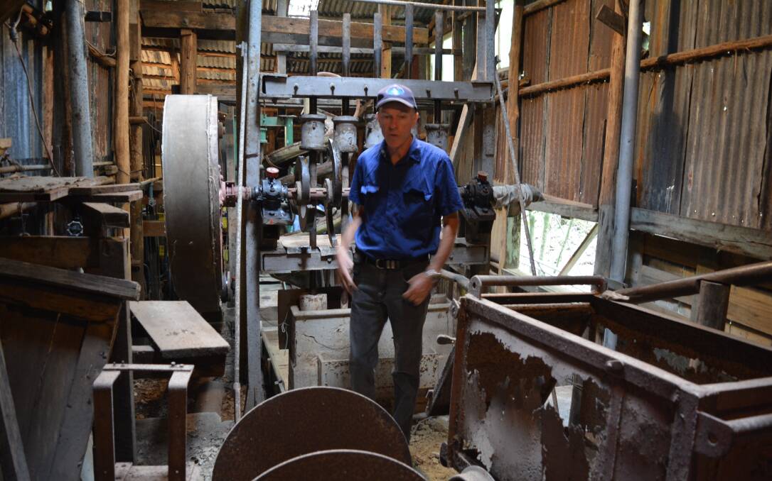 Hunter Valley Vintage Farm Machinery Club president Scott Brooks and the machine