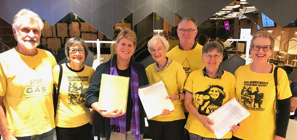 Peter Donley, Kathy McKenzie, Julie Lyford, Marie Flood, Col and Bronwyn Vost and Rhonda Bourne delivering the signed petitions. Photo supplied