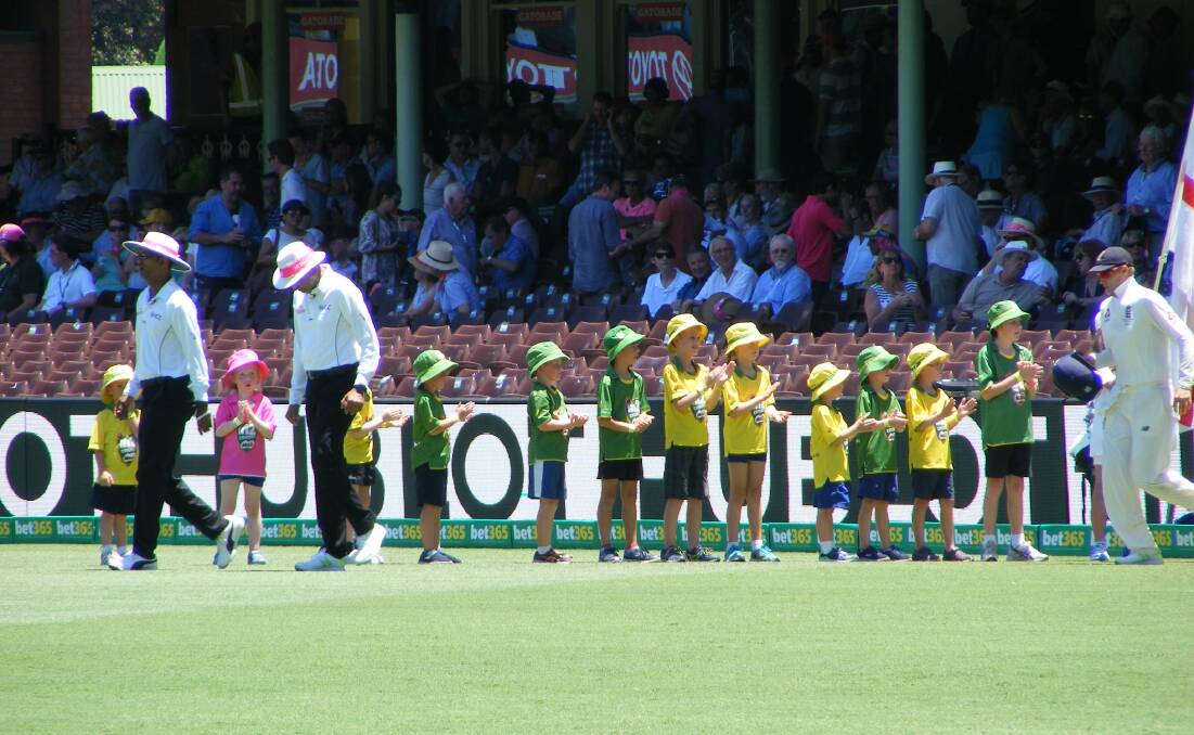 Gloucester Milo cricketers in a guard of honour at the SCG,  with umpires Kumar Dharmasena and Joel Wilson and English cricket captain Joe Root. Photo supplied
