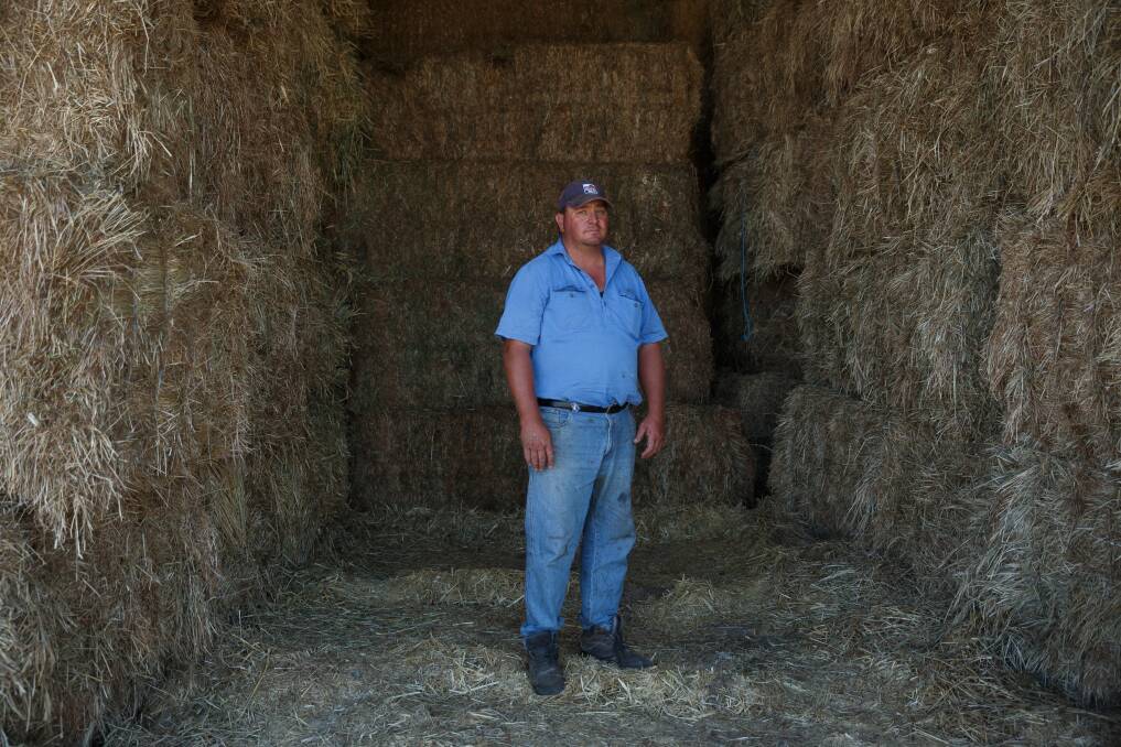 DROUGHT PLEA: Dairy farmer Jamie Marquet with some of the hay bales that are coming to his farm from South Australia. Picture: Max Mason-Hubers.