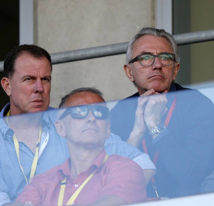 SCOUTING MISSION: New Socceroos coach Bert van Marwijk (right) in the stands at McDonald Jones Stadium on Saturday. Picture: Darren Pateman