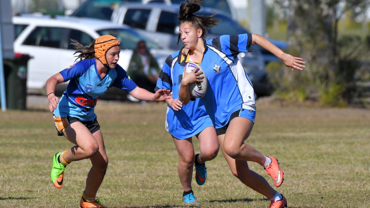 Full steam: St Joseph's Regional College player Ashleigh Grace takes a hit-up on Tuesday.