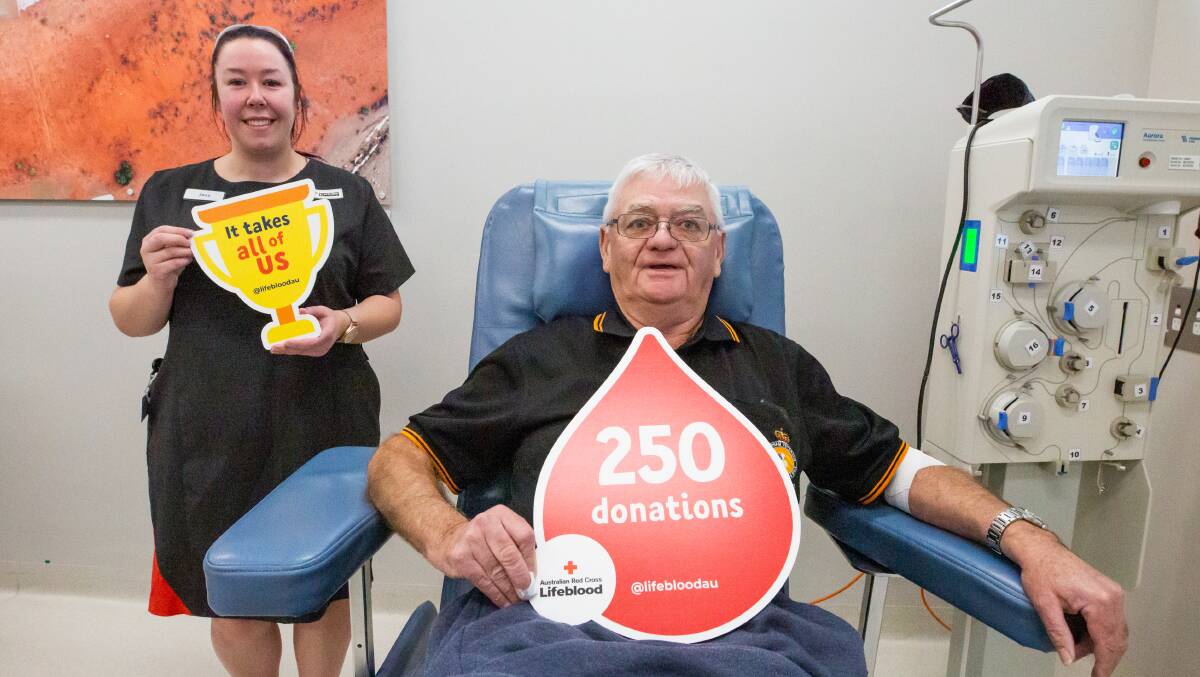 BLOODY LEGEND: Lifeblood Donor Services nursing assistant Jess Tavner with Graeme Johnson for his 250th donation. Photo: Eve Woodhouse
