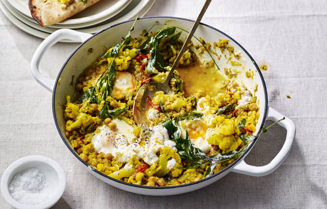 Cauliflower and chickpea masala with poached eggs. Picture: James Moffatt