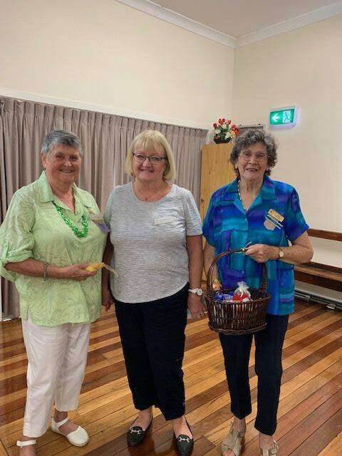 Happy birthday: June McNally and Loris Jones are presented with birthday gifts by Judy Holstein.