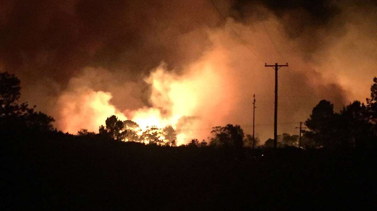 Fire came very close to homes and closed The Lakes Way near Tuncurry on Wednesday evening.  Photo courtesy of NSW RFS Mid Coast.