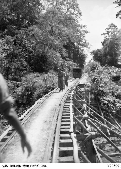 The Hintok Tampi Bridge with Hellfire Pass in the background, after the war. Photo: Australian War Memorial