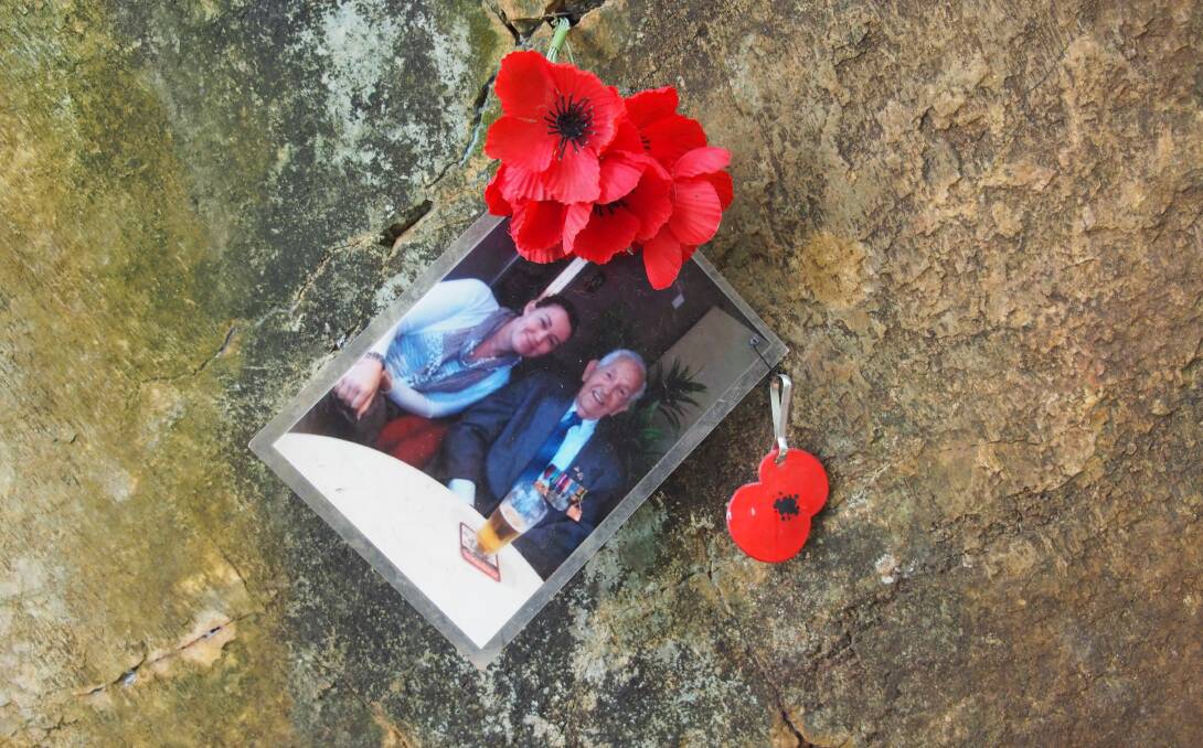 TRIBUTES: This picture left by a visitor and pinned in a crack of the pass tells of happier times after the war.