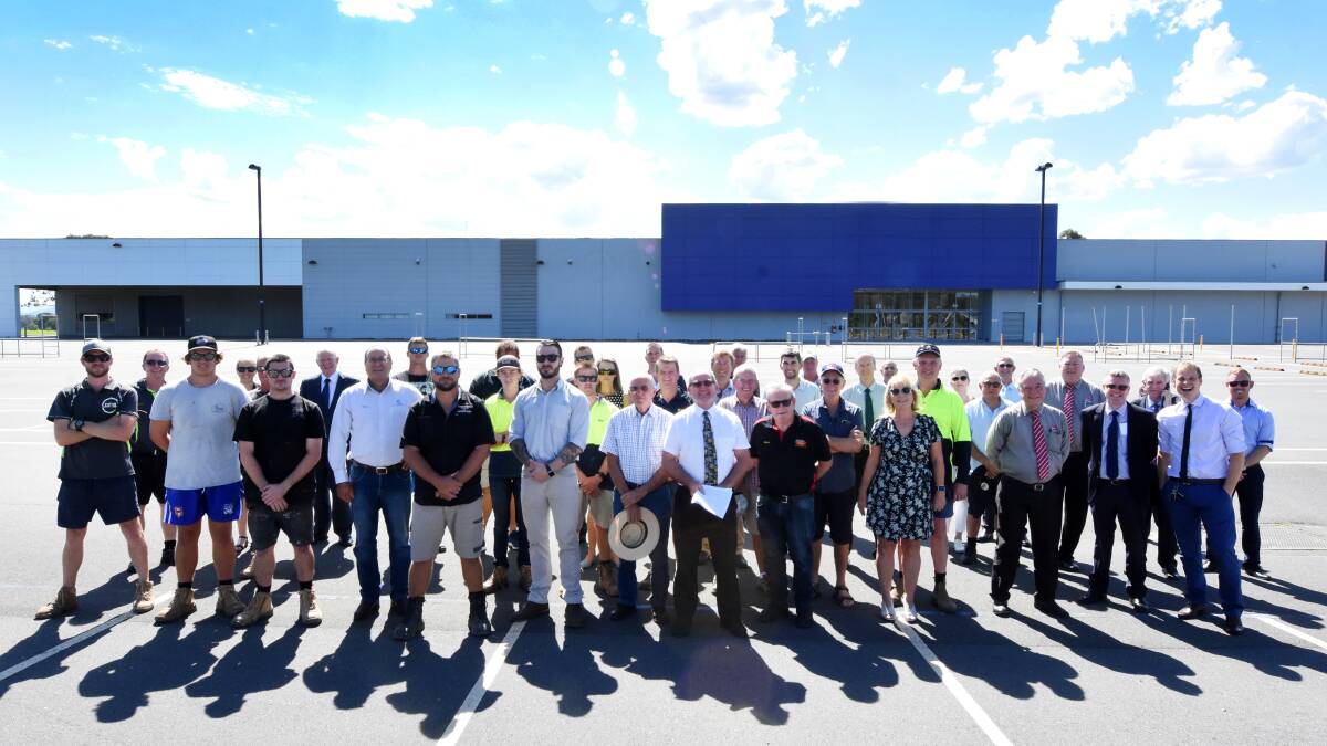 Graham Brown OAM (front centre) and Taree business owners recently gathered to support the MidCoast Council proposal to centralise administration staff in the former Masters building on Biripi Way in Taree.