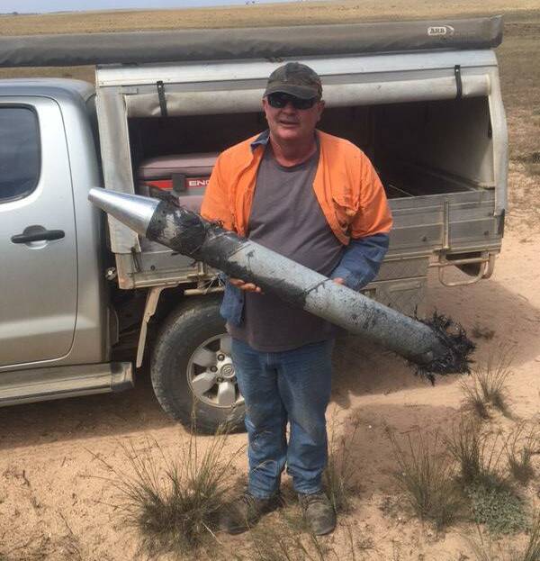 Farmer Jason Hammat with part of the rocket launched by Southern Launch at the Koonibba Test Range that he found on his property. Photo: Supplied