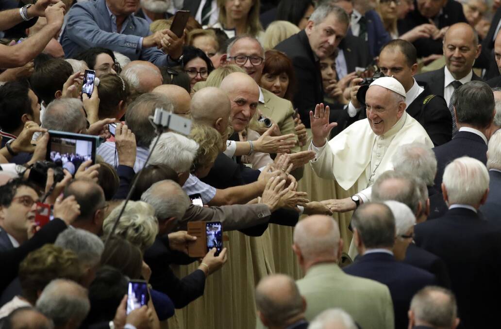 Welcome: Pope Francis greets people in Rome on Sunday as he grapples with a global child sexual abuse crisis.