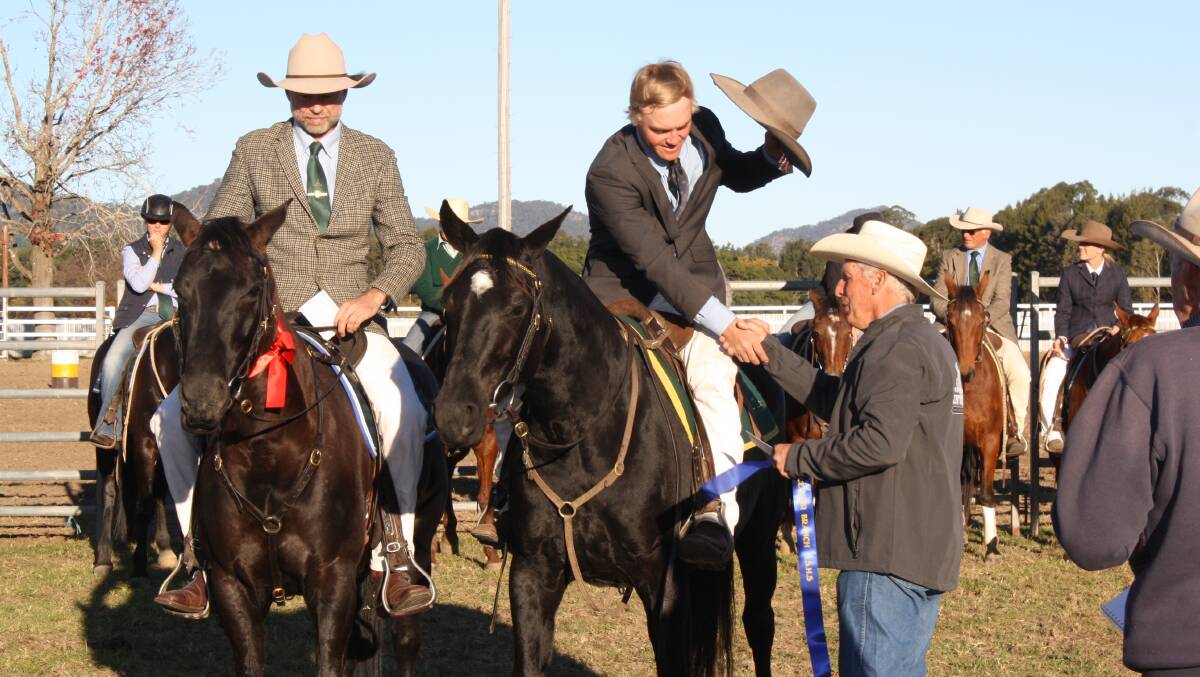 Cutting judge Phil Gray presents winners ribbon to Jack Lawrence while runner-up Hugh Main looks on. Photo supplied