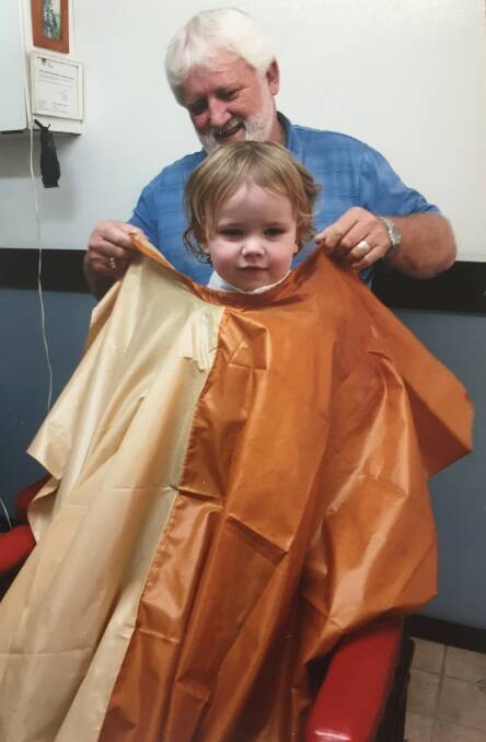Greg giving grandson Parker his first haircut. Photo supplied