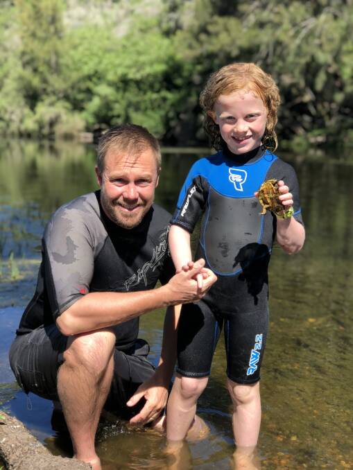 Turtle time: Tim Faulkner, and son Billy, with a Manning River helmeted turtle. Photo: with permission of Tim Faulkner