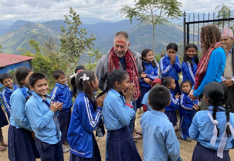 Allan Waldon in Nepal with school children in a rural community. Picture supplied.
