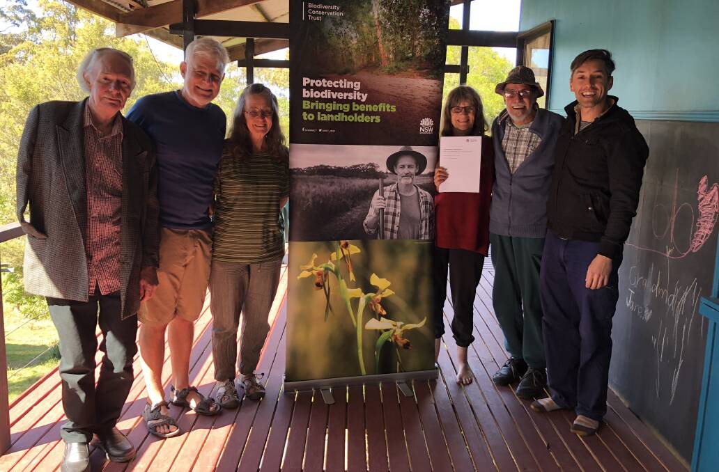 Done deal: Oxygen Farm committee members Norm Sheppard, Mike Roze, Sue Roze, Jane Watson and Ange Martin with Joel Stibbard from the Biodiversity Conservation Trust with the signed agreement. Photo: supplied