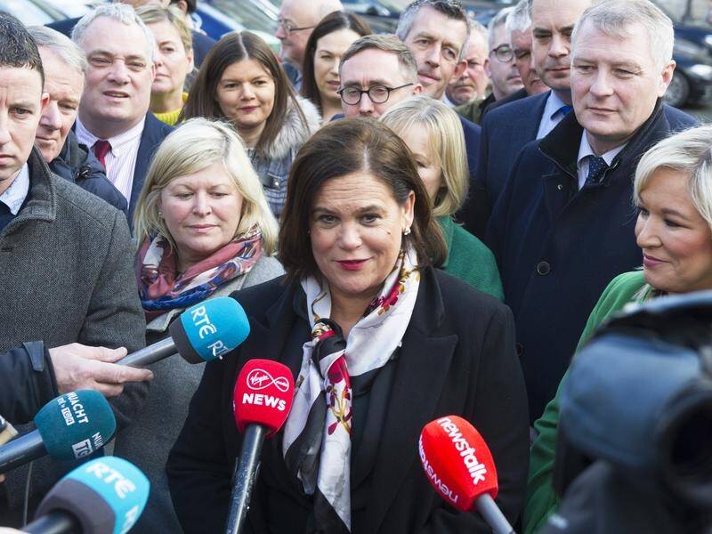Sinn Fein leader Mary Lou McDonald (C) has called Fianna Fail and Fine Gael the "old boys club".