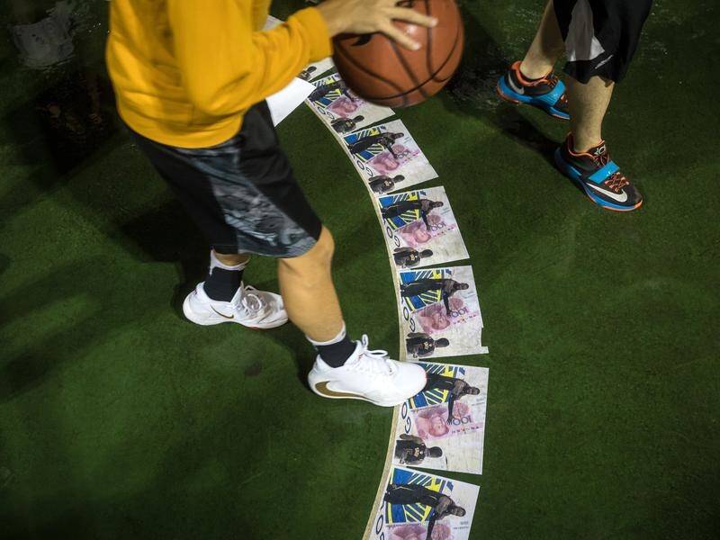 Protesters step on photos of basketball player LeBron James over his comments on Hong Kong's unrest.