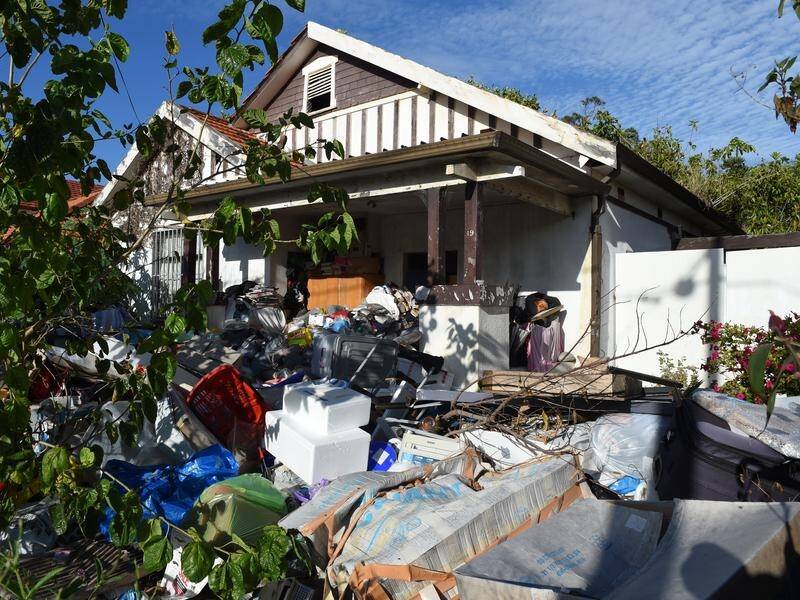 The daughters of the Bondi hoarder are fighting fines for obstructing police during a clean-up.
