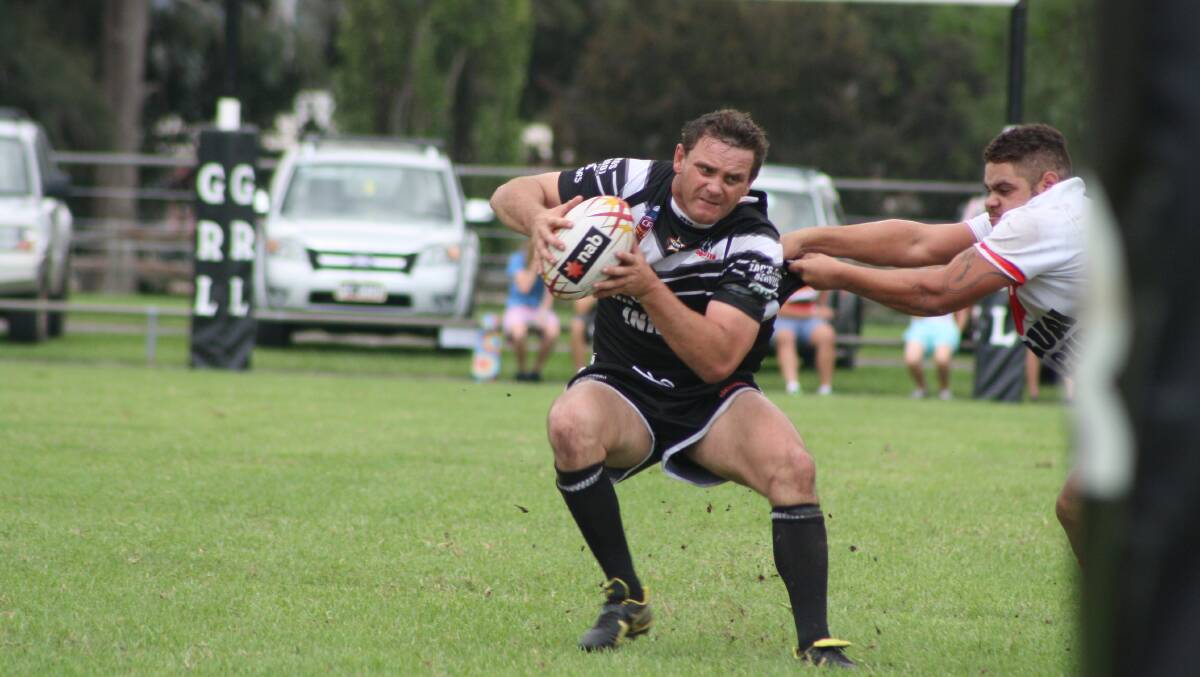 Mick Shultz is tackled by a Karuah defender.