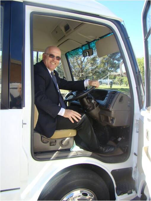 Gloucester High principal Pat Cavanagh takes a ride in the school’s new bus.