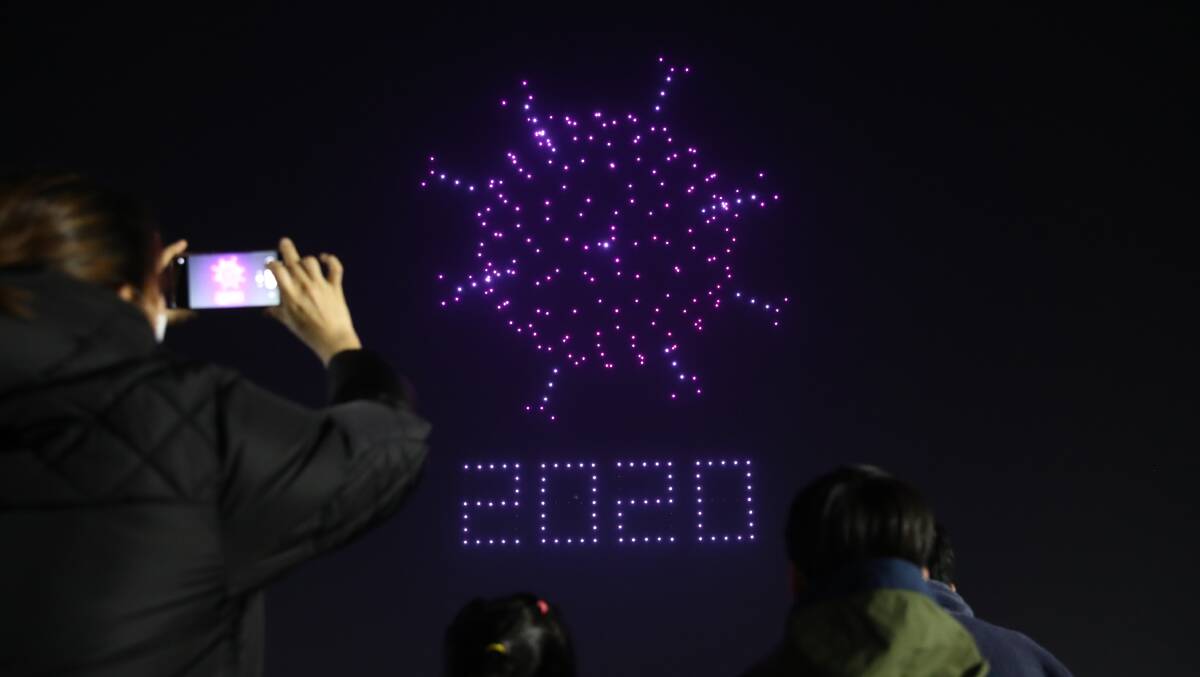Drones spell out messages about COVID-19 above Seoul Olympic Park. Picture: Getty Images