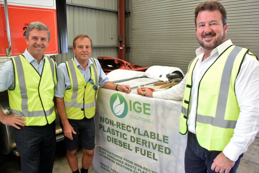 Member for Lyne Dr David Gillespie, Jim Pearson and IGE Solutions chairman Paul Dickson at the Jim Pearson Transport depot in Taree with a container of recycled diesel.