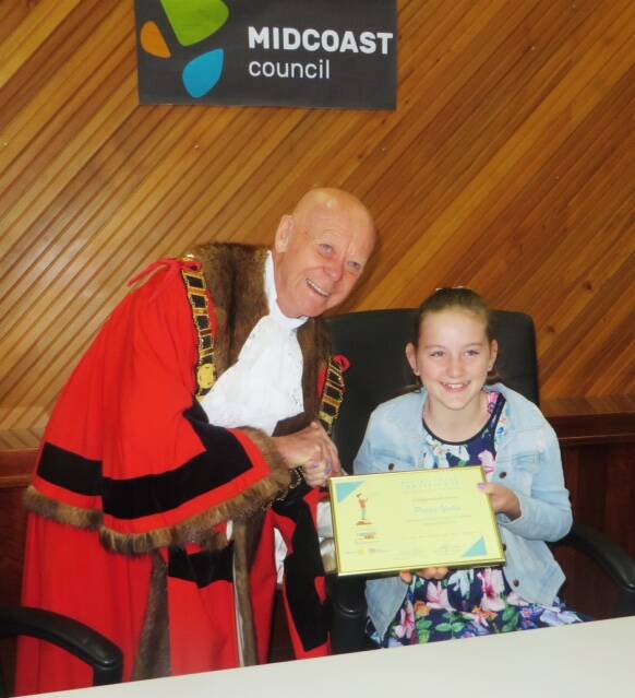 Top prize: MidCoast Council Mayor David West with essay competition winner Poppy Yates. Photo: supplied. 