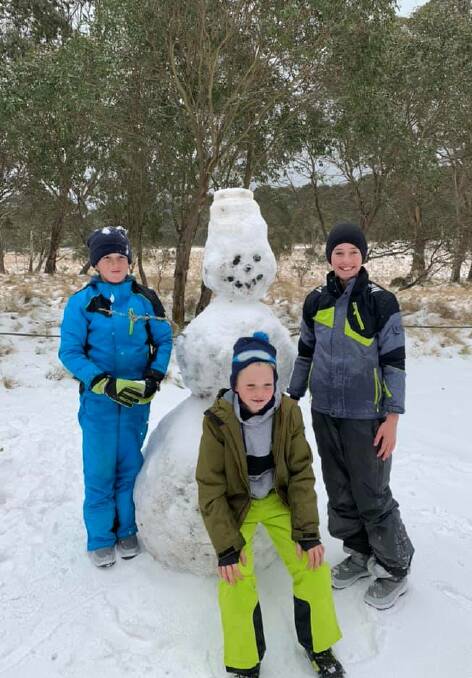 Winter wonderland: Aydn, Oliver and Ryli Schofield at the Polblue campgrounds with Wazza the Snowman. Photo: Craig and Kerri Schofield.