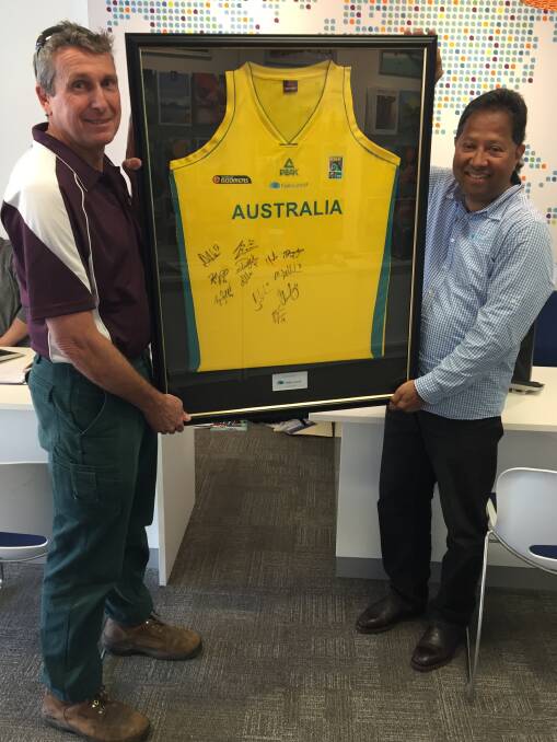 Gloucester Basketball president Chris Reynolds and sponsor Ernie Abeysekera pictured with the major raffle prize of a signed Australian Boomers jersey.