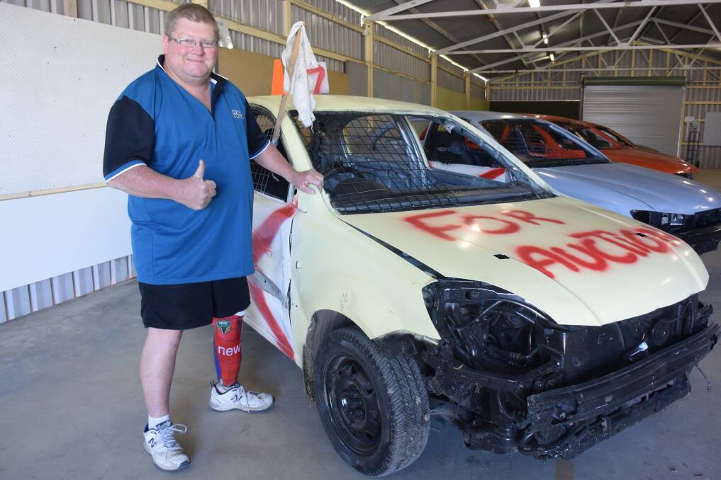 Under the hammer: Chris Taylor with one of the cars up for grabs in the auction. It is part of the Farmers Friends Drought Relief Concert and Family Fun Afternoon at Taree Showground. Photo: Rob Douglas.
