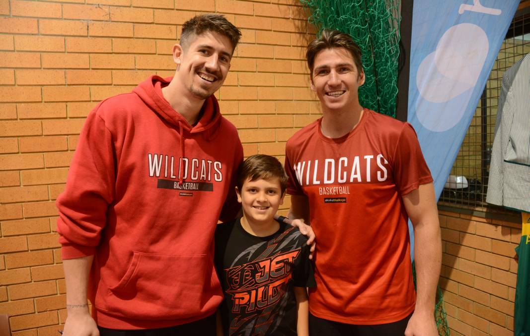 Idols: Blake Walker (centre) with Perth Wildcats players Damian Martin and Greg Hire during the basketball clinic in Gloucester. Photo: Scott Calvin. 