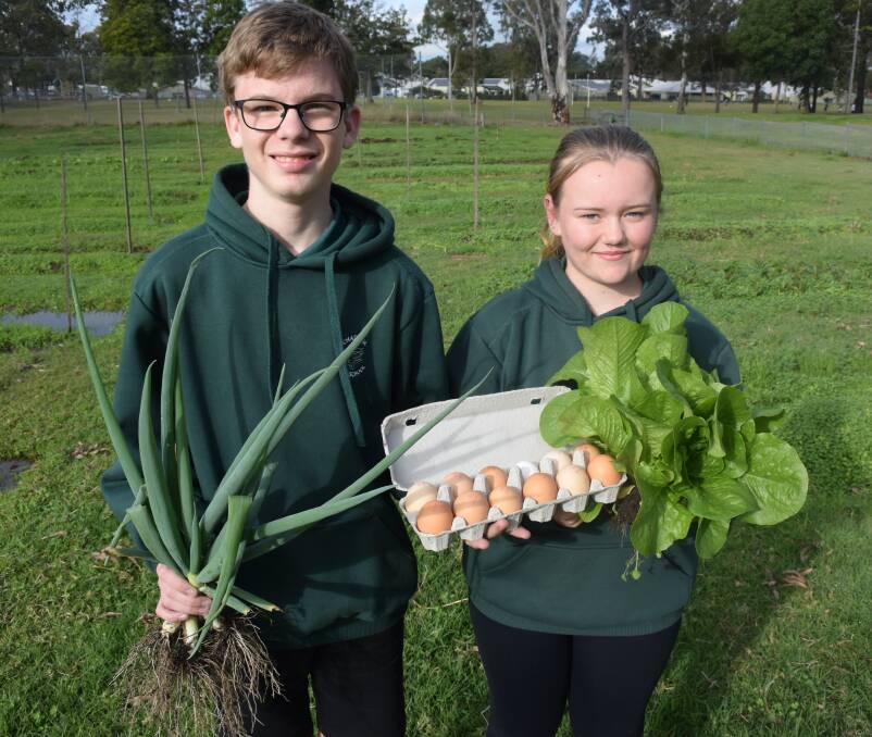 Produce galore: Students Jeremy Kelly and Kimberly Peacock with an ensemble of spring onions, eggs and cos lettuce grown at Chatham High School. Photo: Rob Douglas. 