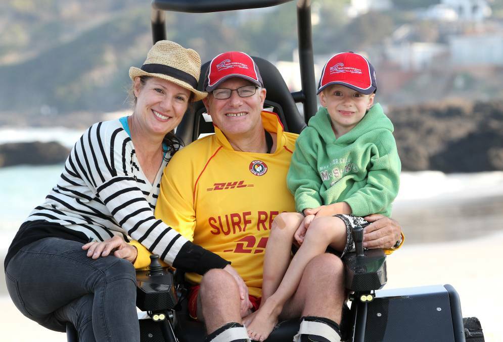 BEACHLIFE: Kirk Dicker in an all terrain wheelchair that allowed him to visit the beach with partner Joanna and son Anthony.