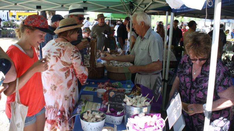 Shoppers sample some of the many garlic products on sale.