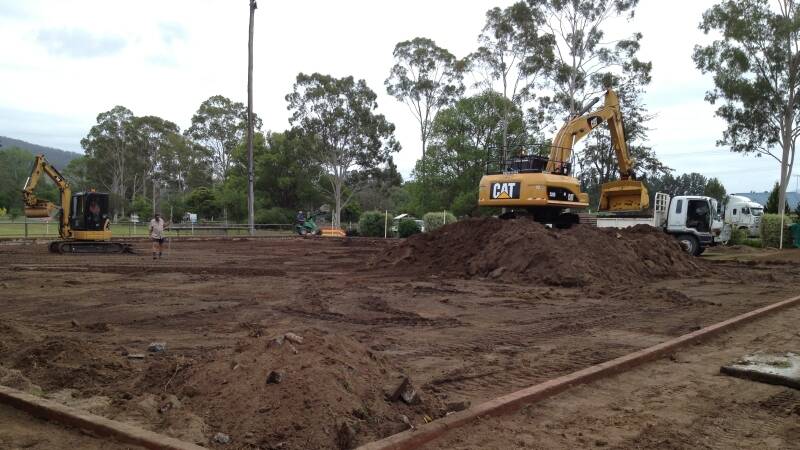 Workers excavate the turf green at Gloucester Bowling Club in preparation for the new synthetic playing surface.