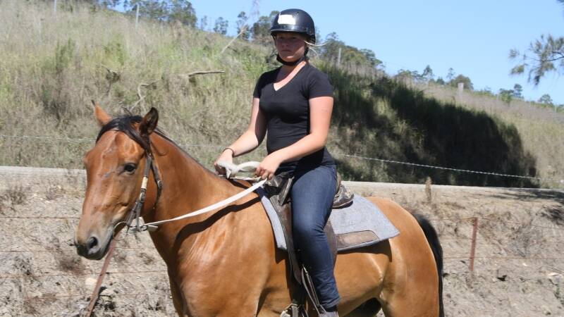 Lizzie Smith enjoy's the sun on a ride at Camp Cobark.